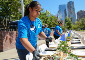 Sister Na’a places food on the Mile Long Table